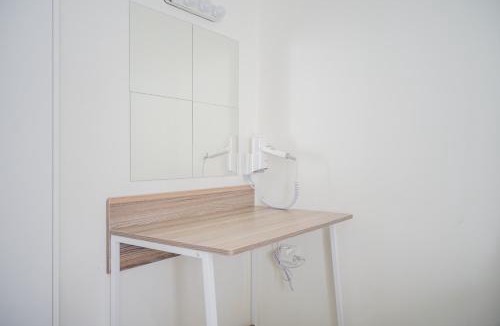 Pinang Apartment | Minimalist Studio Bintaro Icon Apartment near British School By Travelio