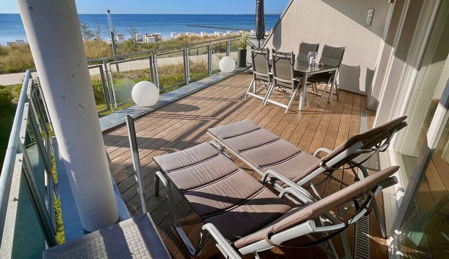 Dream vacation apartment Ostseeresidenz 4 in Großenbrode. Inviting terrace with fantastic sea views and comfortable furniture to relax on. Exclusive wellness bathroom with sauna & feel-good corner bathtub in Großenbrode